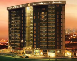 Exterior view of the Hm Vacation Club at Dubai Creek at night.