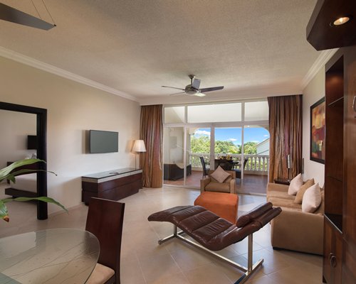 A well furnished bedroom with a king bed and outside view.