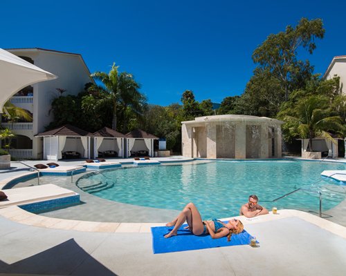 An outdoor swimming pool with beach beds.