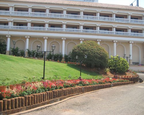 Scenic exterior view and pathway to The Lagoona Resort with multiple balconies.