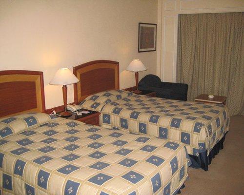 A well furnished bedroom with two beds.