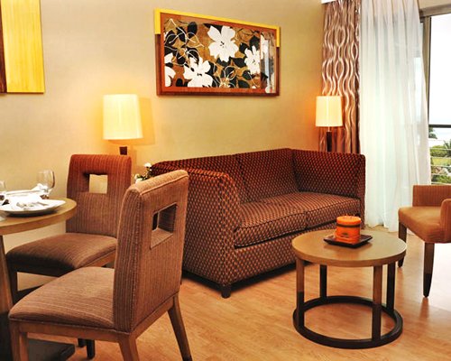 A well furnished living room with a dining area.