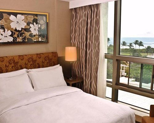 A well furnished bedroom with an outside view.
