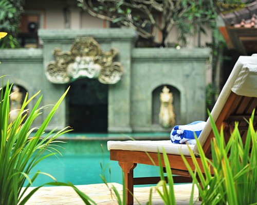 An outdoor swimming pool with chaise lounge chairs.