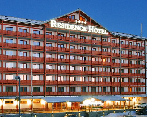View of the multi story balconies of the Residence Hotel at dusk.