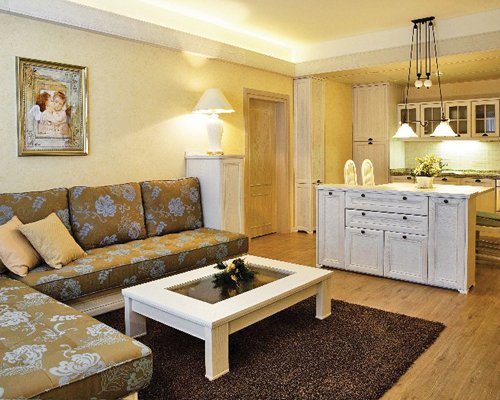 A well furnished living room with an open plan kitchen.