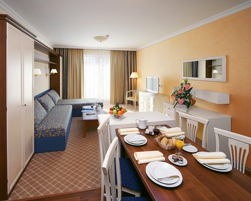 A well furnished living room with a dining area.