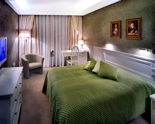 A well furnished bedroom with a television.