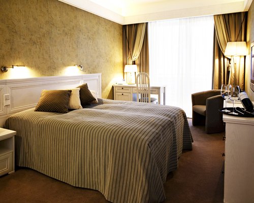 A well furnished bedroom with a king bed.