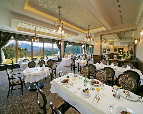 A well furnished indoor fine dining restaurant with outside view.