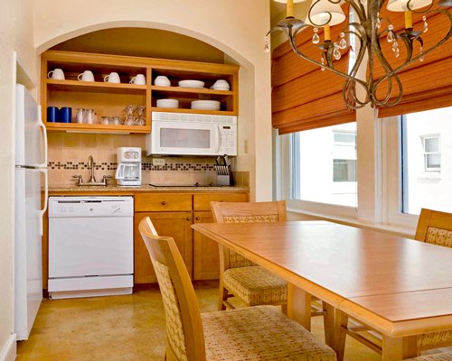 An open plan kitchen with wooden dining area.