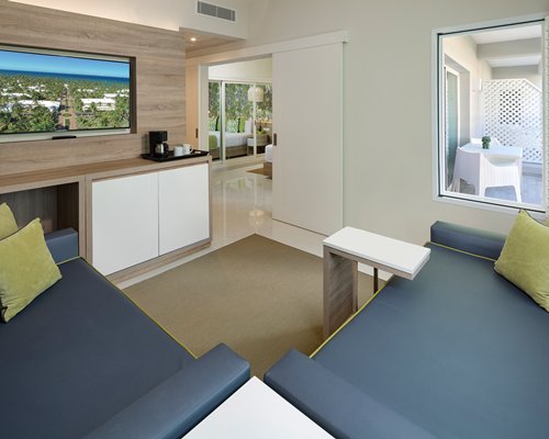 A bathroom with bathtub shower and a double sink vanity.