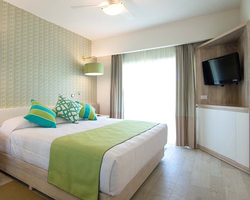 A well furnished bedroom with an outside view.