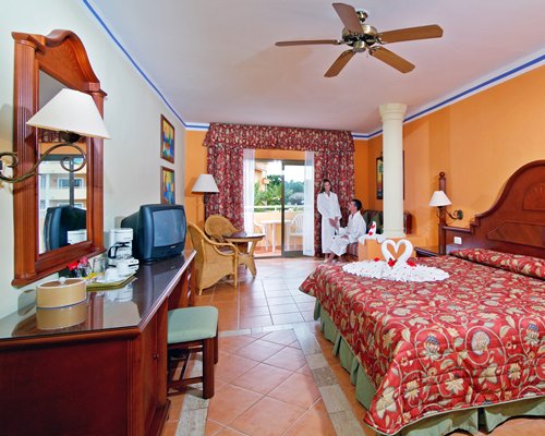 A well furnished living room with a television dining area and bedroom.