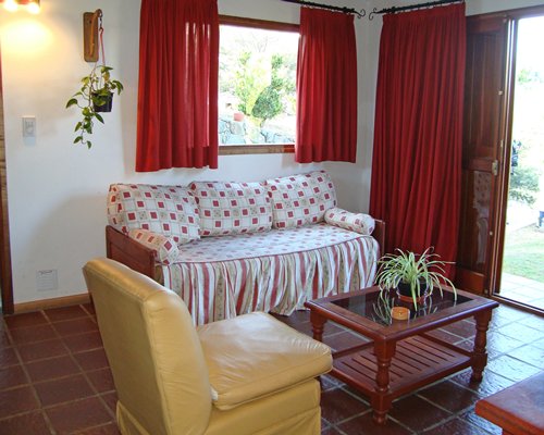 A well furnished living area with sofas and an outside view.