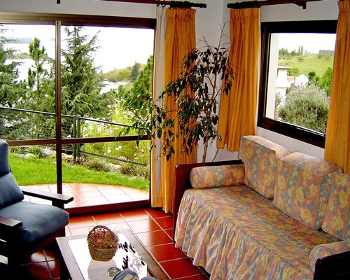 Living room with a pull out sofa and an outside view.