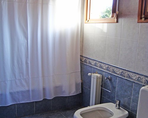 A bathroom with bathtub and shower.
