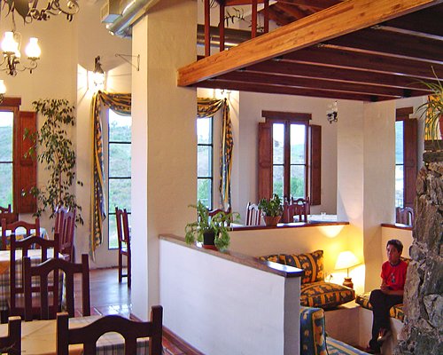 An indoor fine dining area and a recreation room with an outside view.
