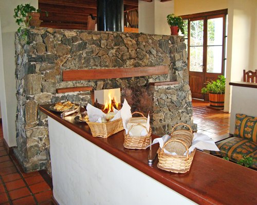 A well furnished living room with a fire in the fireplace.