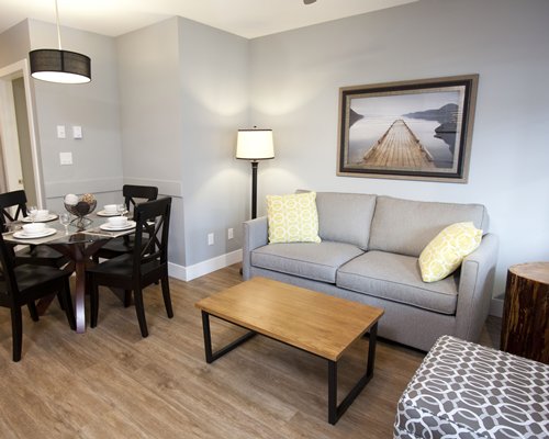 A well furnished living room with a pull out sofa and dining area.