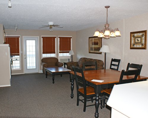 A well furnished living room with a dining area and outside view.