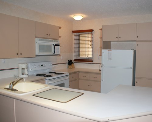 A well equipped kitchen with a microwave oven.