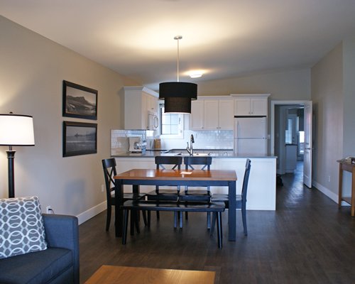 A well furnished living room with an open plan kitchen and dining area.