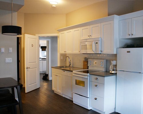 A well equipped kitchen with a microwave oven.