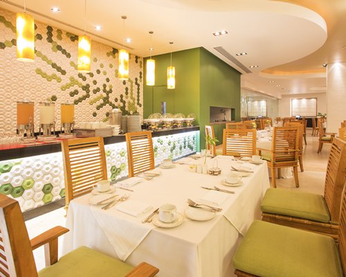 An indoor restaurant with a buffet at Marival Residences Luxury Resort.
