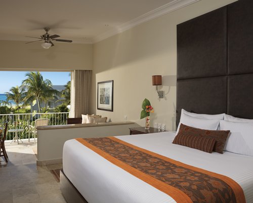 A well furnished bedroom with patio and hammock.