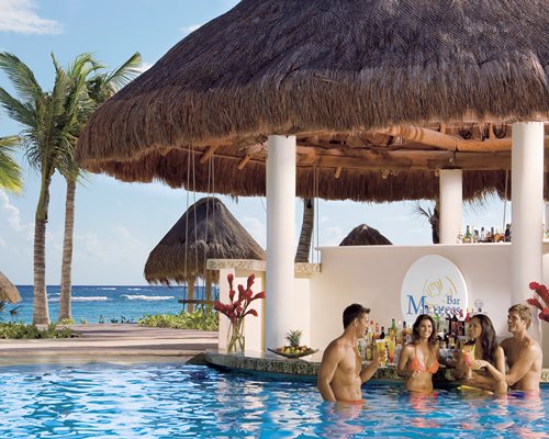 A group of people in a poolside bar.