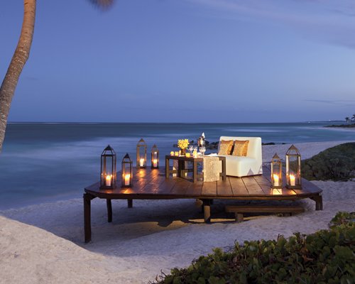 Beach side private dining area with a love seat.