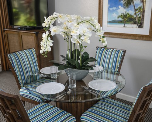 A well furnished living room with an open plan kitchen and dining area.