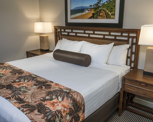 A well furnished bedroom with a king bed.