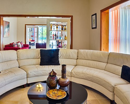A well furnished living and dining area with a television and an outside view.