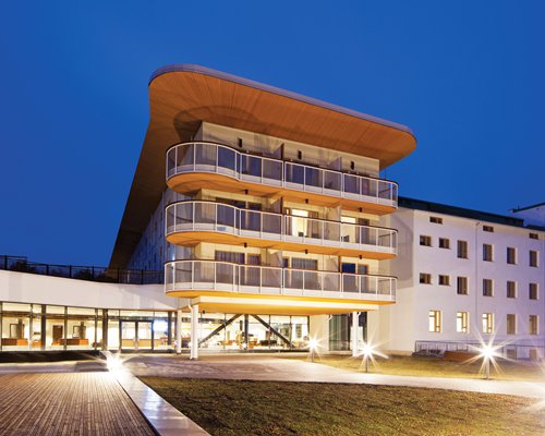 An exterior view of multi story resort units at night.