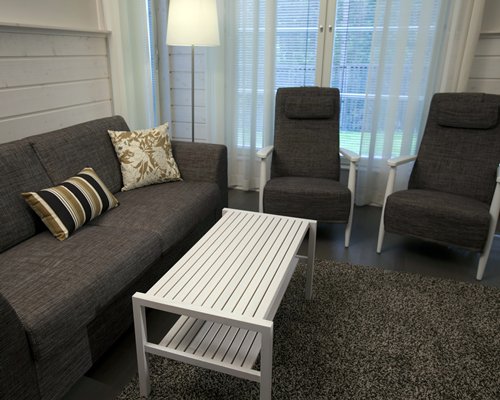 A well furnished living room with sofas and an outside view.