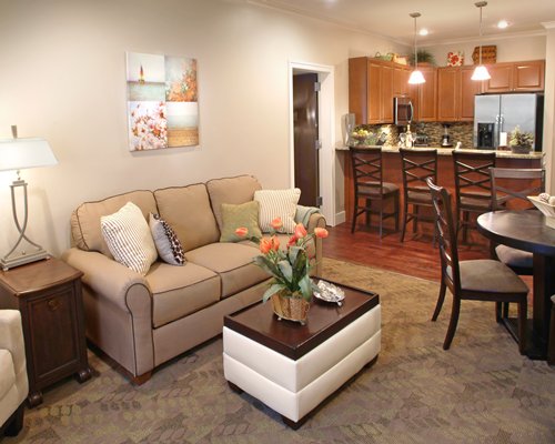 A well furnished living room with an open plan kitchen and dining area.