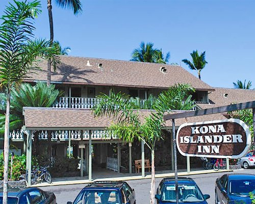 Signboard of Kona Islander Inn resort alongside the parking lot.