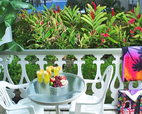 A view of patio furniture alongside landscaping.