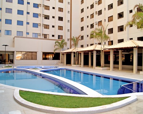 An outdoor swimming pool alongside resort units.