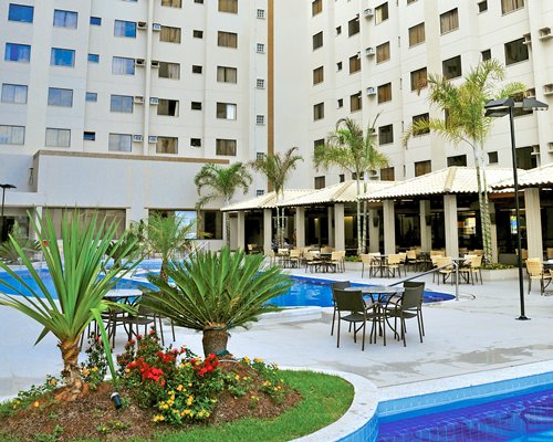 Scenic exterior view of Thermas Boulevard Suite Hotel with outdoor swimming pool and outdoor restaurant.