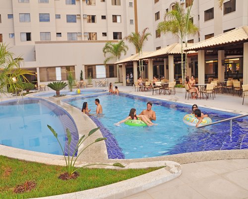 An outdoor swimming pool alongside resort units.