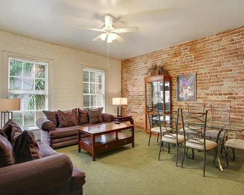 A well furnished living room with dining area and an outside view.