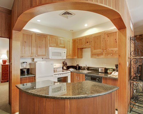 A well equipped kitchen with a microwave oven and a breakfast bar.