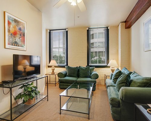 A well furnished living room with a pull out sofa and television.