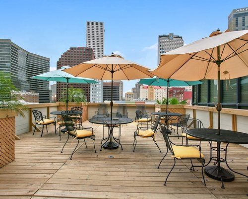 View of skyscrapers from the balcony with outdoor dining and sunshades.