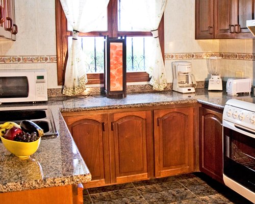 A well equipped kitchen with a microwave oven.
