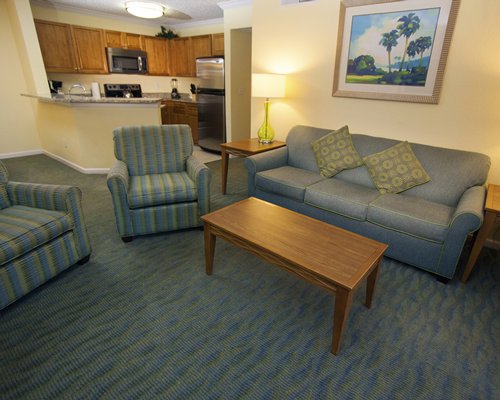 A well furnished living room with an open plan kitchen.