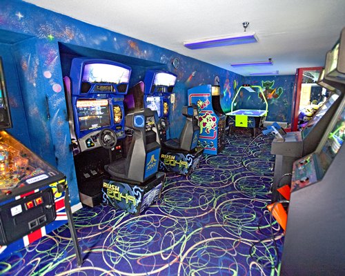 An indoor recreation room with air hockey and arcade games.